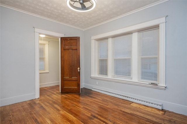 unfurnished room featuring a textured ceiling, a baseboard radiator, hardwood / wood-style flooring, and ornamental molding