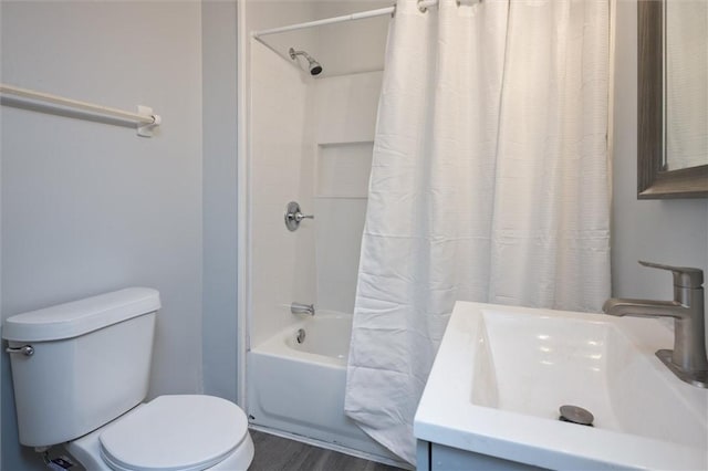 full bathroom featuring hardwood / wood-style floors, vanity, shower / bath combination with curtain, and toilet