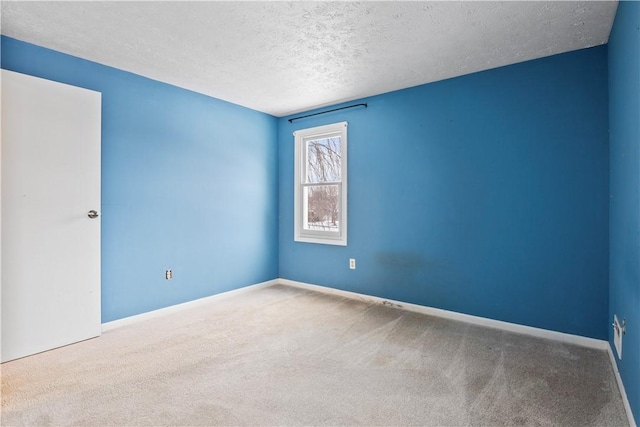 carpeted spare room featuring a textured ceiling