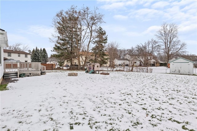 snowy yard with a wooden deck