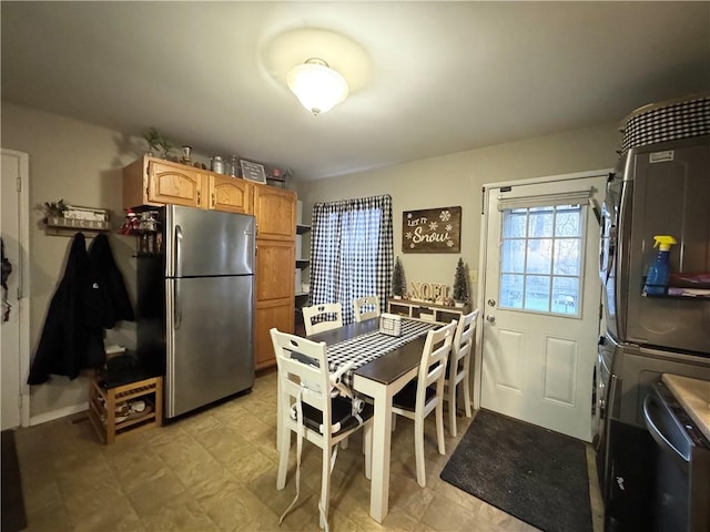 kitchen featuring stacked washer and dryer and stainless steel refrigerator