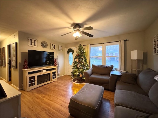 living room featuring hardwood / wood-style floors and ceiling fan