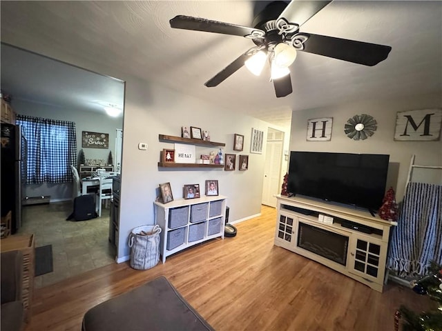 living room with ceiling fan and hardwood / wood-style flooring