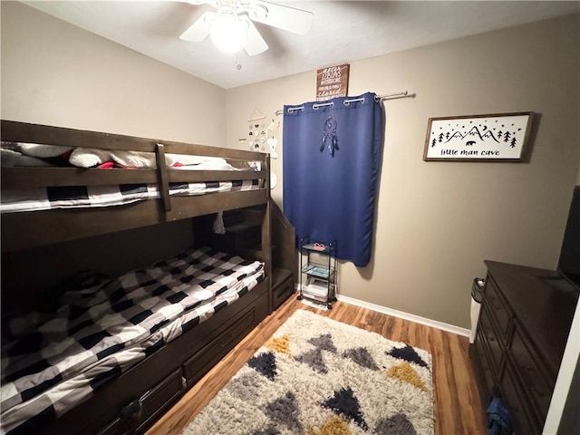 bedroom with ceiling fan and wood-type flooring