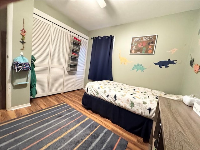 bedroom featuring ceiling fan, a closet, and wood-type flooring