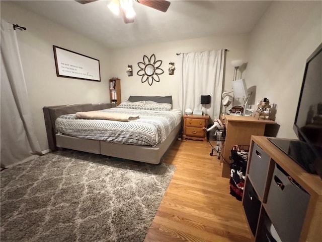 bedroom with ceiling fan and hardwood / wood-style flooring