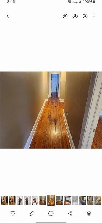 corridor with hardwood / wood-style flooring