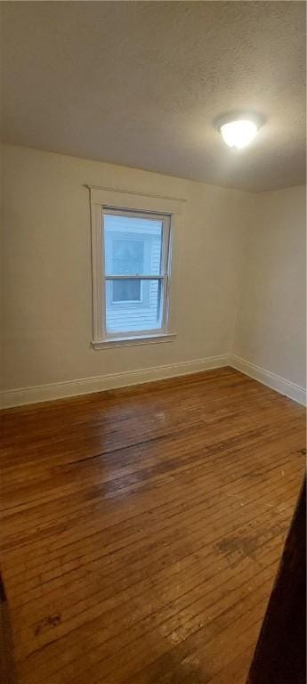 spare room featuring hardwood / wood-style floors