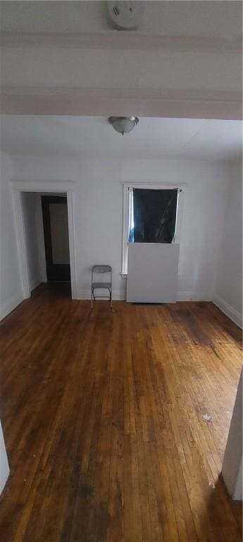 spare room featuring dark wood-type flooring