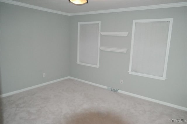 carpeted empty room featuring crown molding