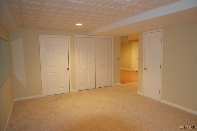 unfurnished bedroom with carpet floors and multiple closets