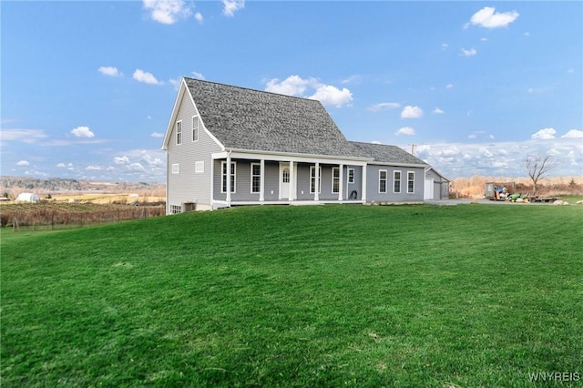 back of property featuring a lawn and covered porch