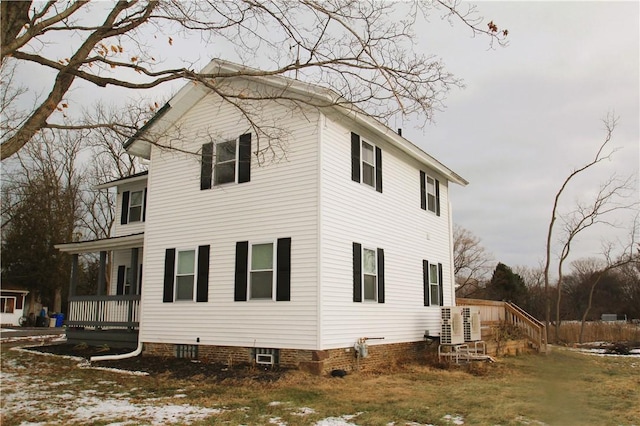 view of side of home with covered porch