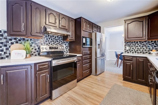 kitchen featuring dark brown cabinets, light hardwood / wood-style flooring, and appliances with stainless steel finishes