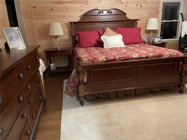 bedroom with wood walls