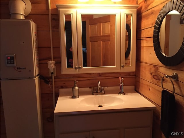 bathroom with vanity and wood walls