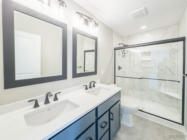 bathroom with walk in shower, vanity, tile patterned flooring, and toilet