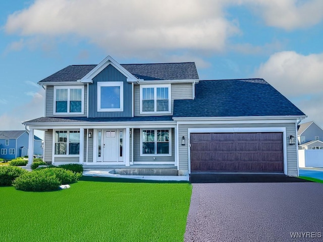 view of front of house with a front lawn and a garage