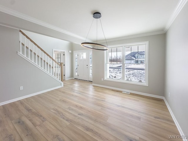 interior space featuring ornamental molding and light hardwood / wood-style floors