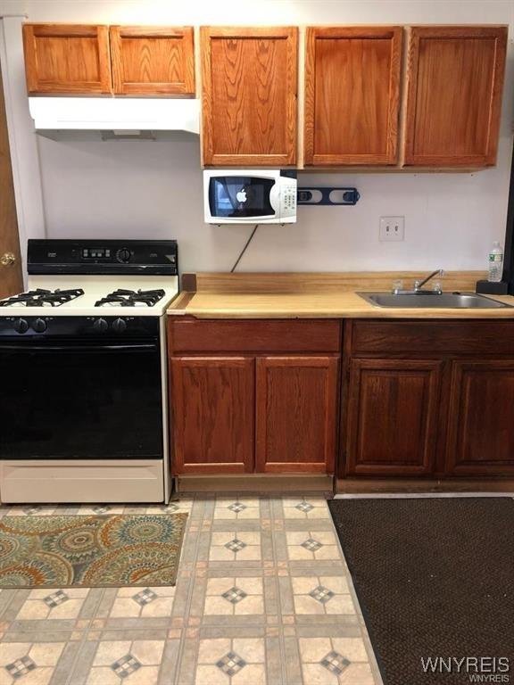 kitchen featuring sink and white appliances