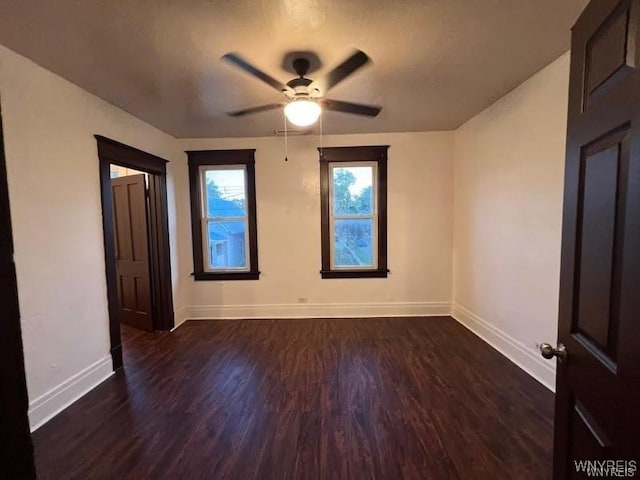 spare room with ceiling fan and dark hardwood / wood-style flooring