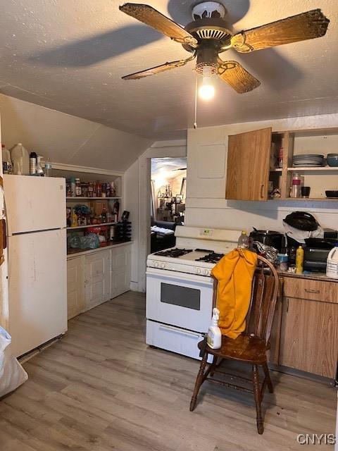 kitchen with a textured ceiling, white appliances, open shelves, light wood finished floors, and brown cabinetry