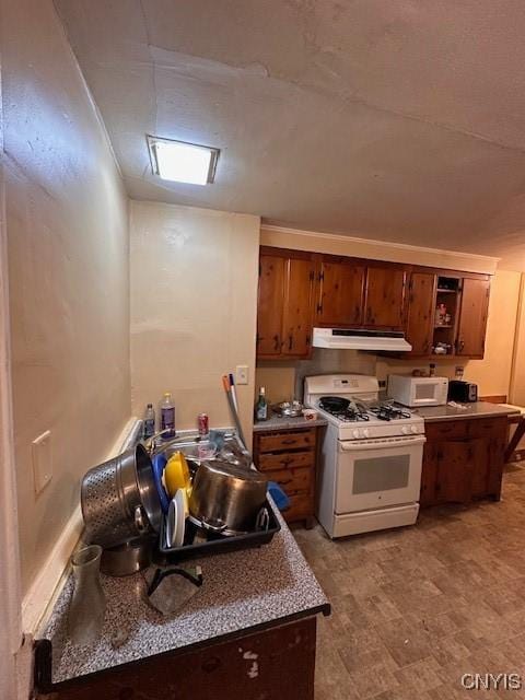 kitchen featuring white appliances, brown cabinets, under cabinet range hood, and open shelves