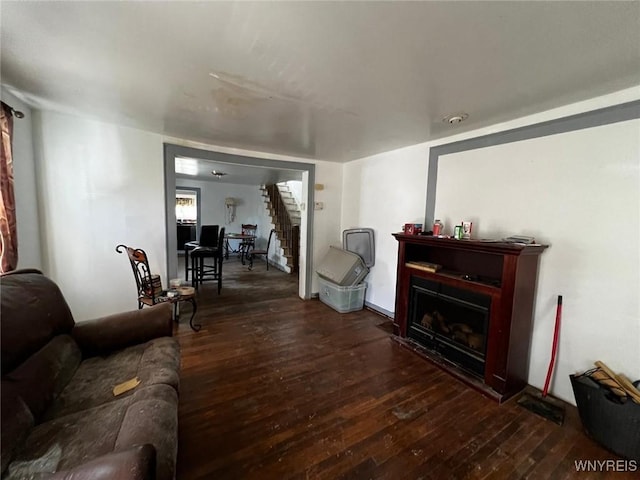 living room featuring dark hardwood / wood-style floors and a fireplace