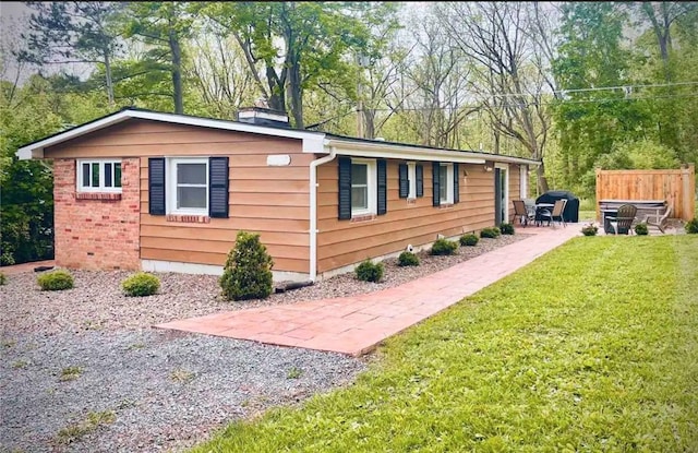 view of home's exterior featuring a patio area and a yard