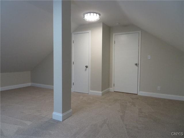 bonus room with light colored carpet and lofted ceiling