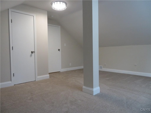 additional living space with light colored carpet and lofted ceiling