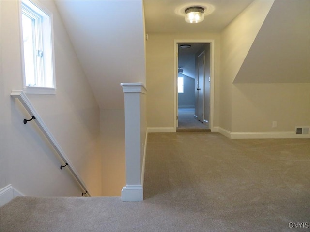 interior space with carpet, plenty of natural light, and lofted ceiling