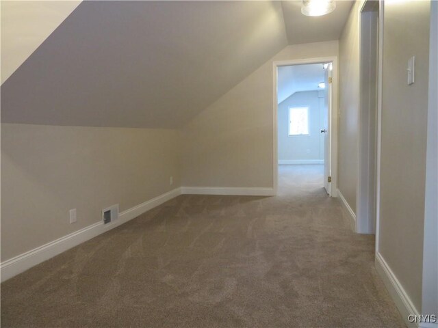 bonus room featuring carpet floors and vaulted ceiling