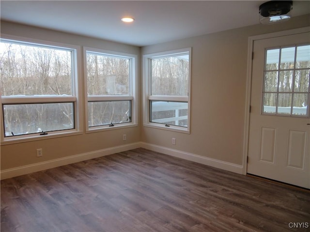 unfurnished dining area featuring dark hardwood / wood-style flooring and a healthy amount of sunlight