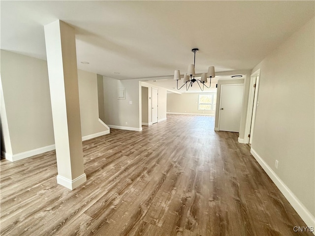 unfurnished dining area with light wood-type flooring and an inviting chandelier