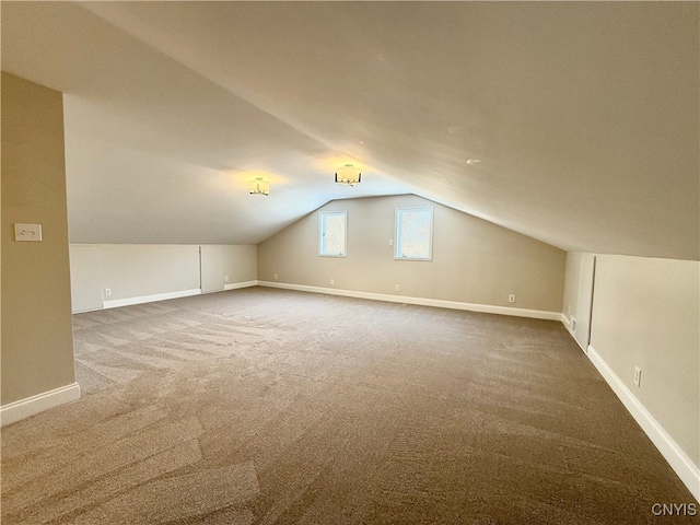 bonus room featuring carpet floors and vaulted ceiling