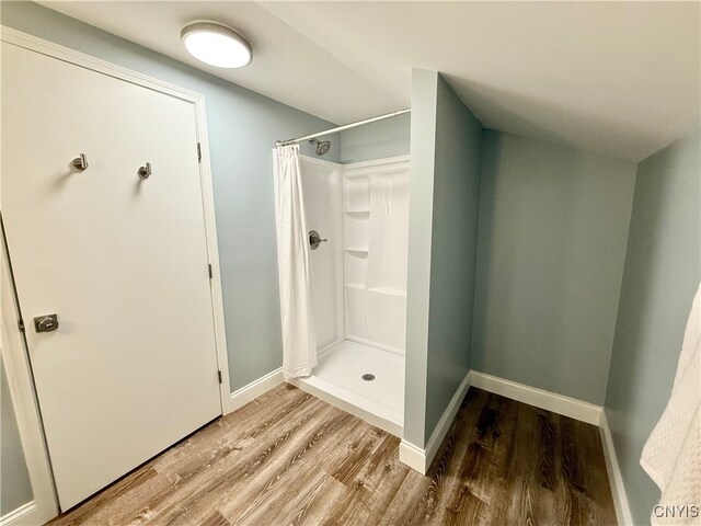 bathroom featuring hardwood / wood-style flooring and curtained shower