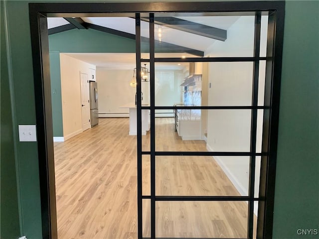 details with beam ceiling, a baseboard heating unit, hardwood / wood-style flooring, and stainless steel refrigerator