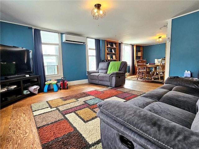 living room featuring a wall mounted air conditioner and hardwood / wood-style flooring