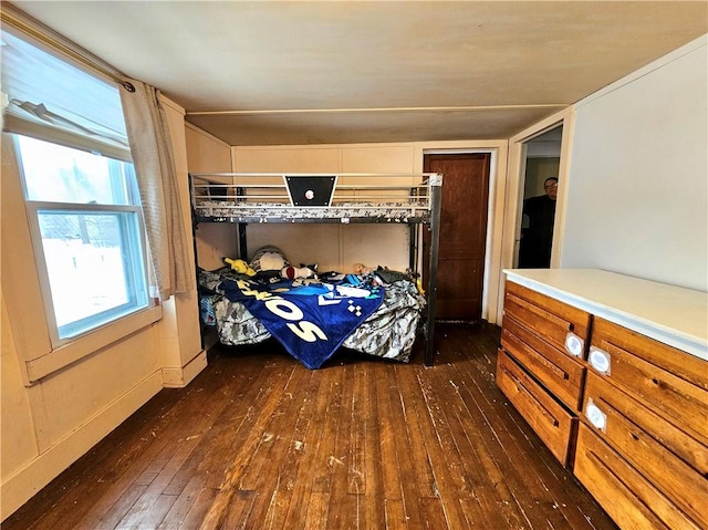 bedroom with dark wood-type flooring