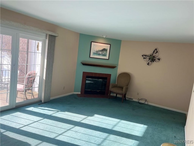 unfurnished room with a tile fireplace and carpet floors