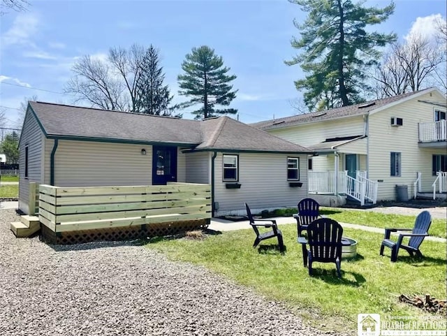 view of front of house with a front lawn and an outdoor fire pit