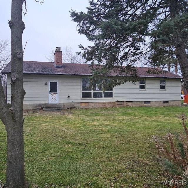 rear view of house with a lawn