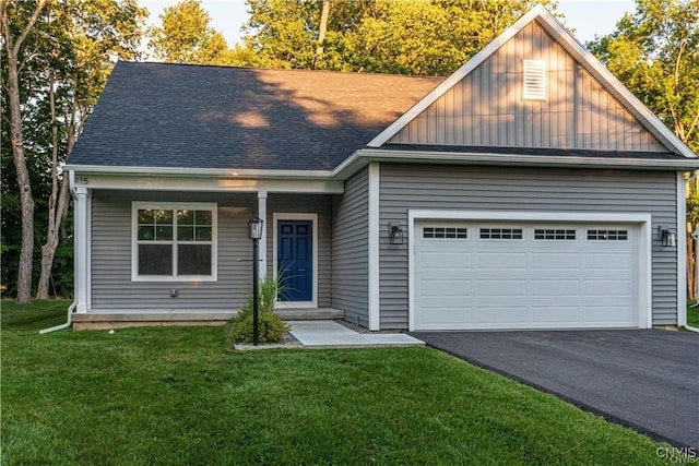 view of front of house featuring a front yard and a garage