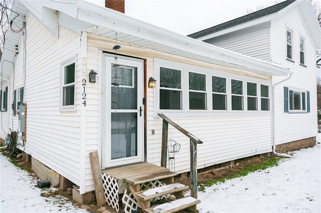 view of snow covered property entrance