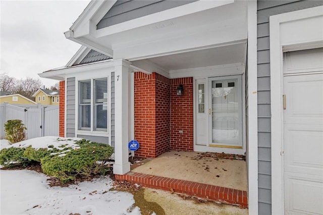 view of snow covered property entrance