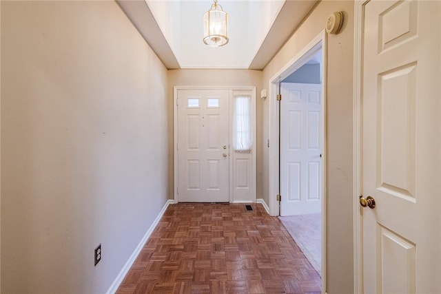 doorway to outside with dark parquet floors