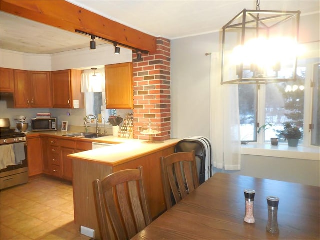 kitchen featuring kitchen peninsula, rail lighting, sink, hanging light fixtures, and stainless steel electric range