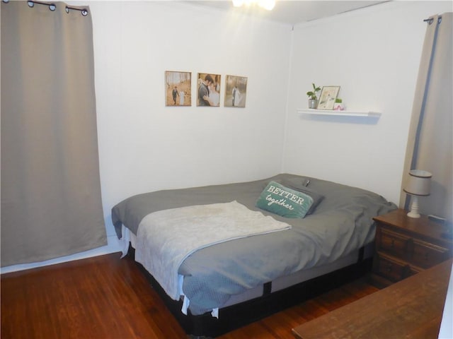 bedroom with dark hardwood / wood-style floors