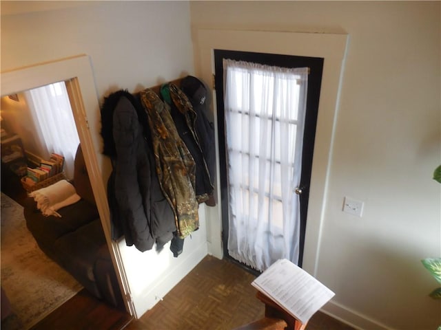 entryway with dark parquet flooring